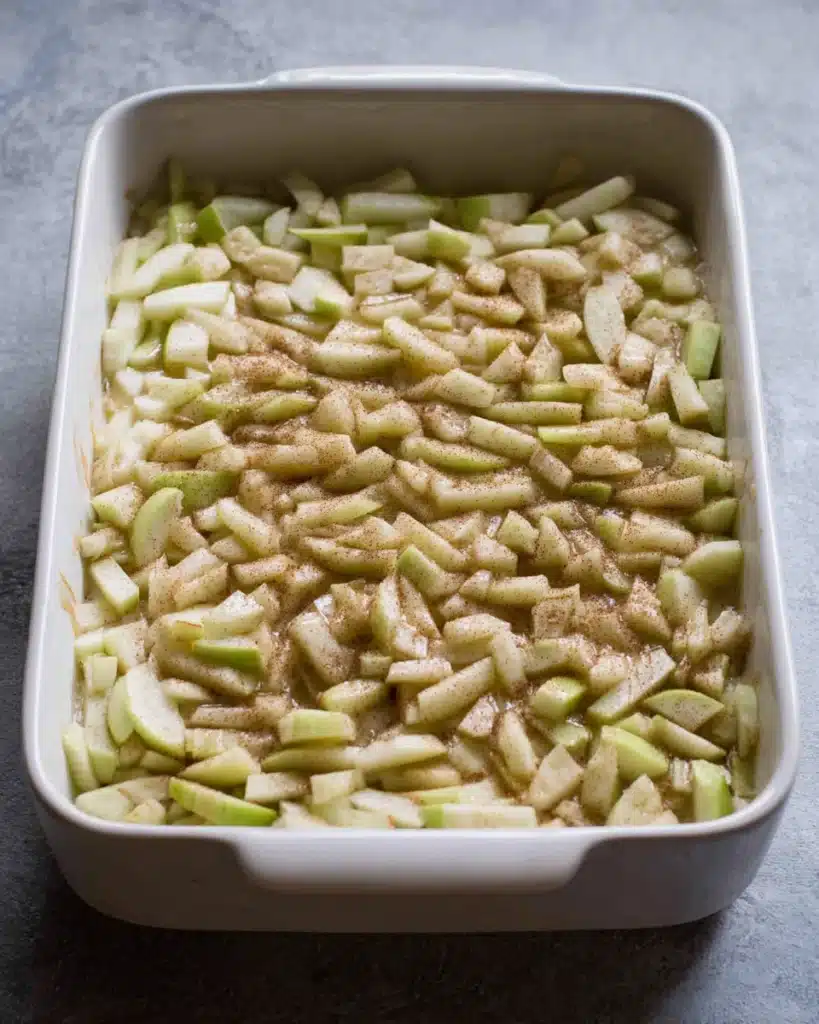 Chopped apple layer added to cheesecake filling for Apple Cheesecake Bars