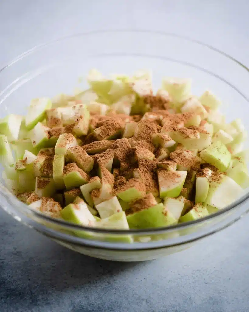 Chopped Granny Smith apples with cinnamon for Apple Cheesecake Bars