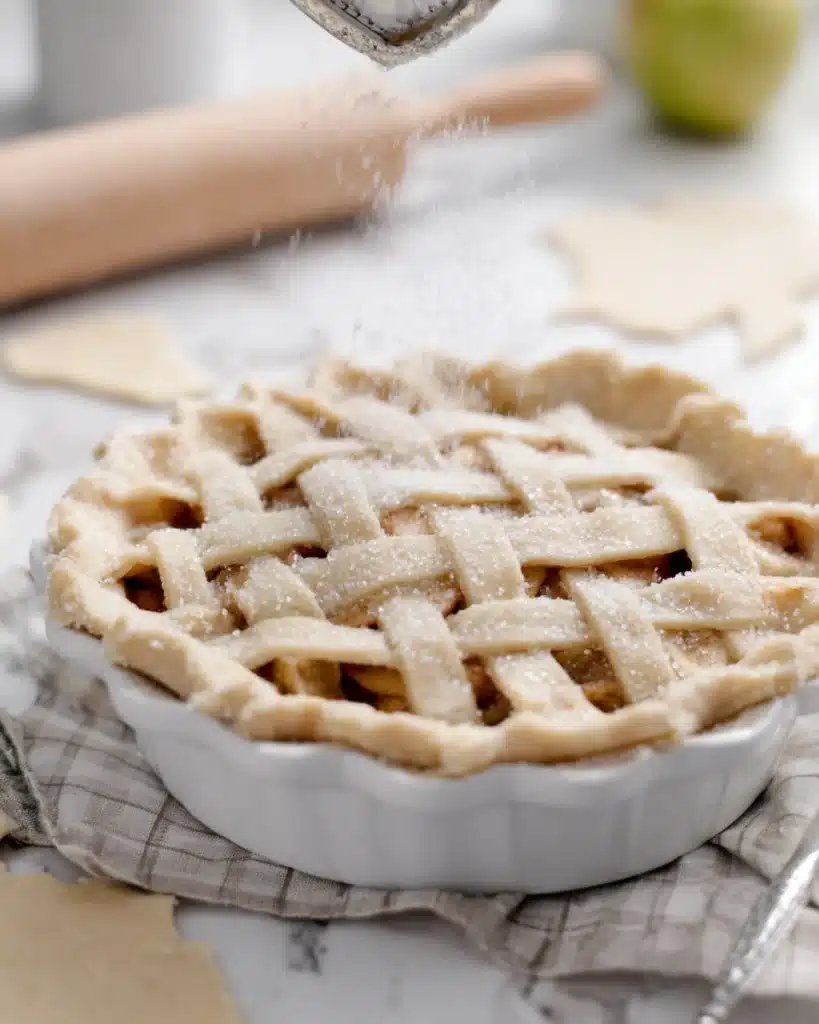 Apple Pie Recipe – Classic Thanksgiving Dessert 4 Sprinkling sugar on unbaked lattice apple pie crust