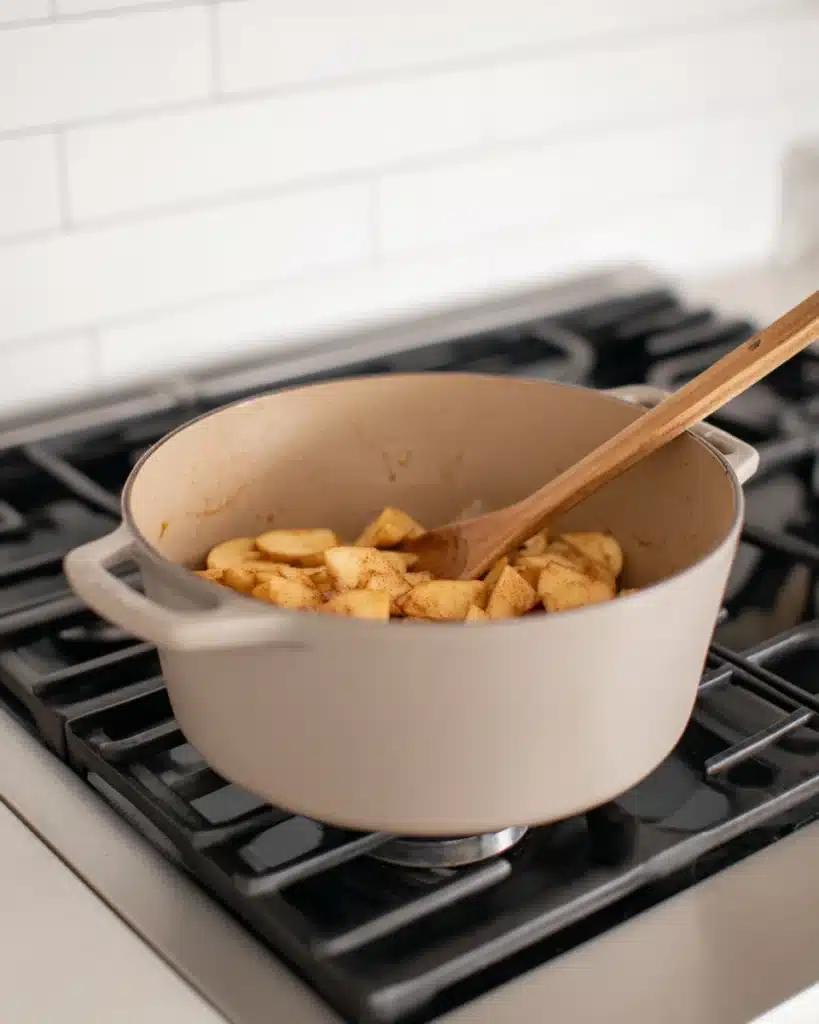 Apple Pie Recipe – Classic Thanksgiving Dessert 3 Apple pie filling with cinnamon cooking in pot on stovetop