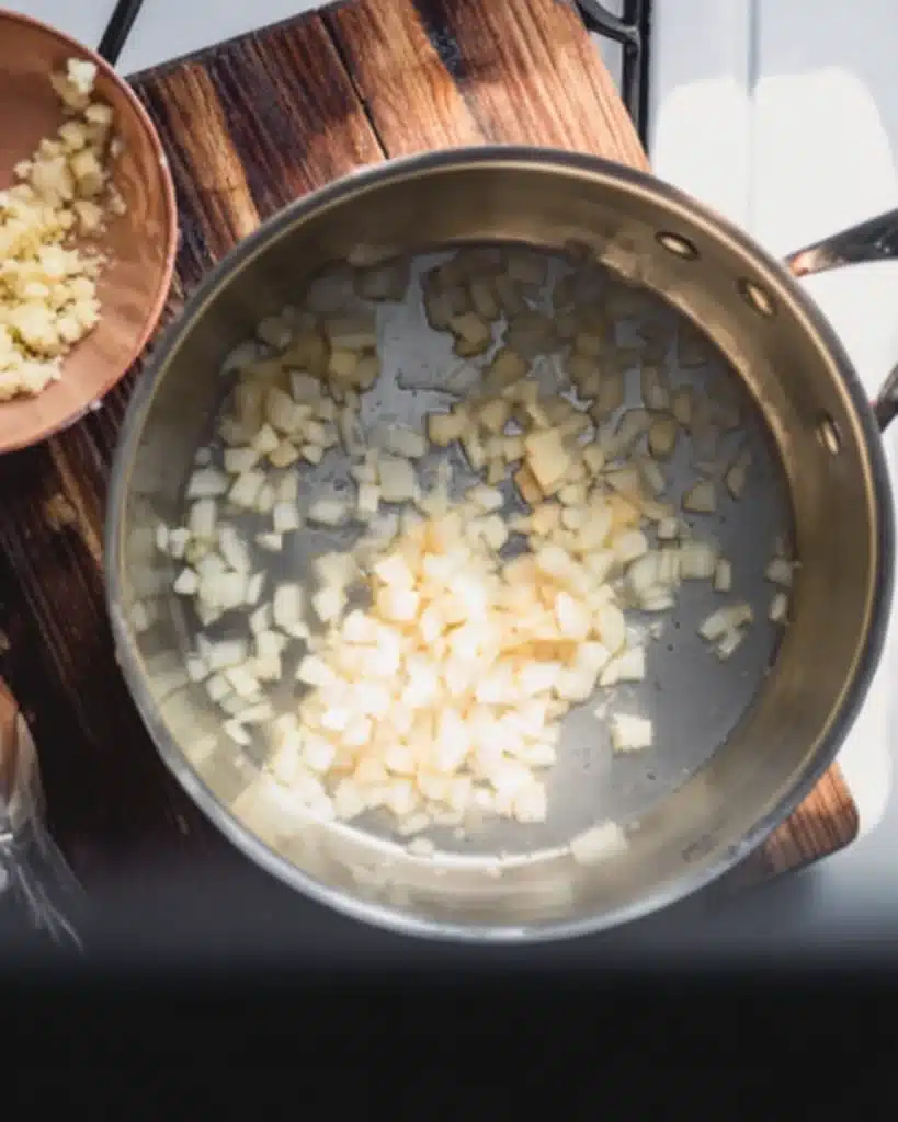 Cheddar Cheese Potato Soup Recipe 2 Sautéing onions with minced garlic in a stainless steel pot