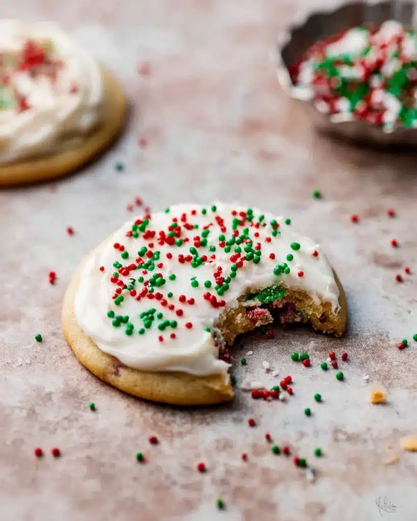 Christmas Sprinkle Cookies 7 Frosted Christmas sprinkle cookie with a bite taken out
