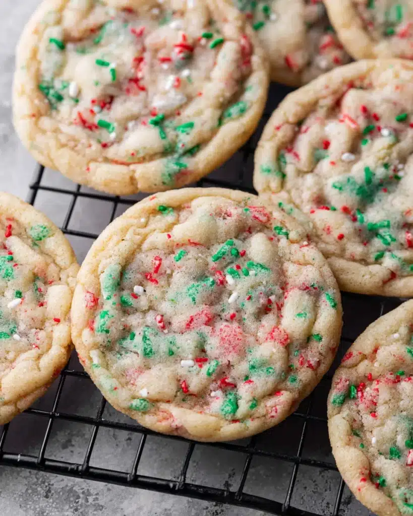 Christmas Sprinkle Cookies 6 Baked Christmas sprinkle cookies cooling on a wire rack