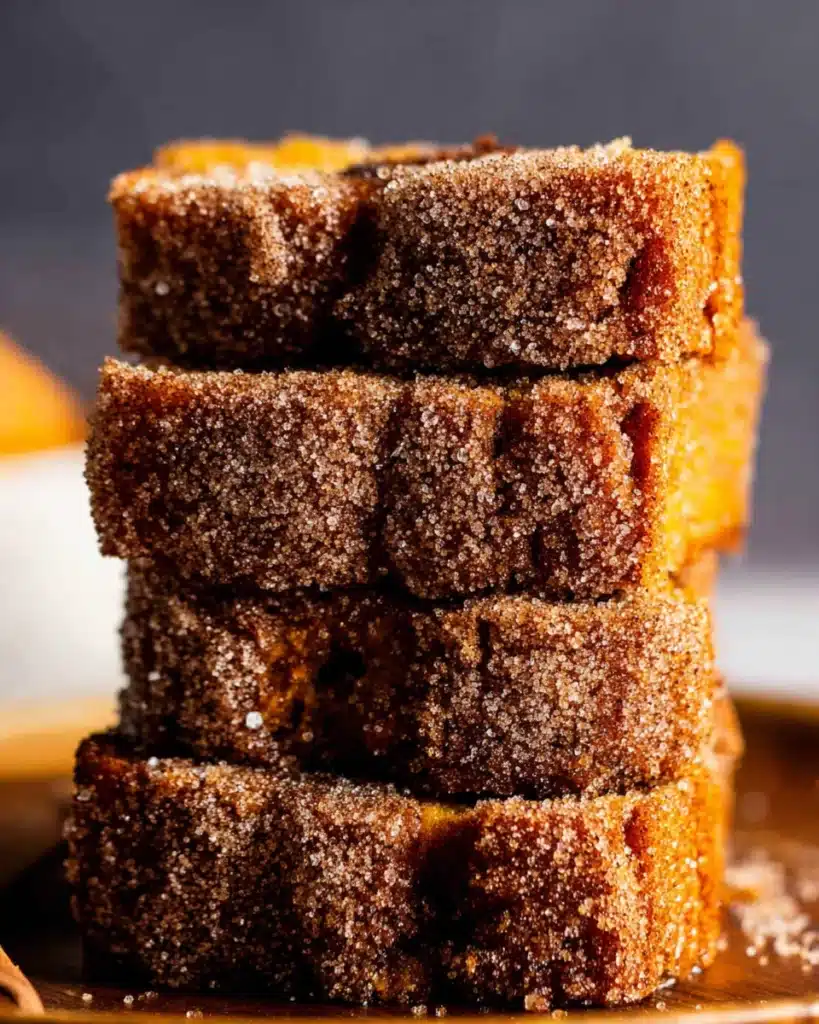 Cinnamon Swirl Pumpkin Bread Recipe 7 Stack of sliced cinnamon swirl pumpkin bread with sugar topping