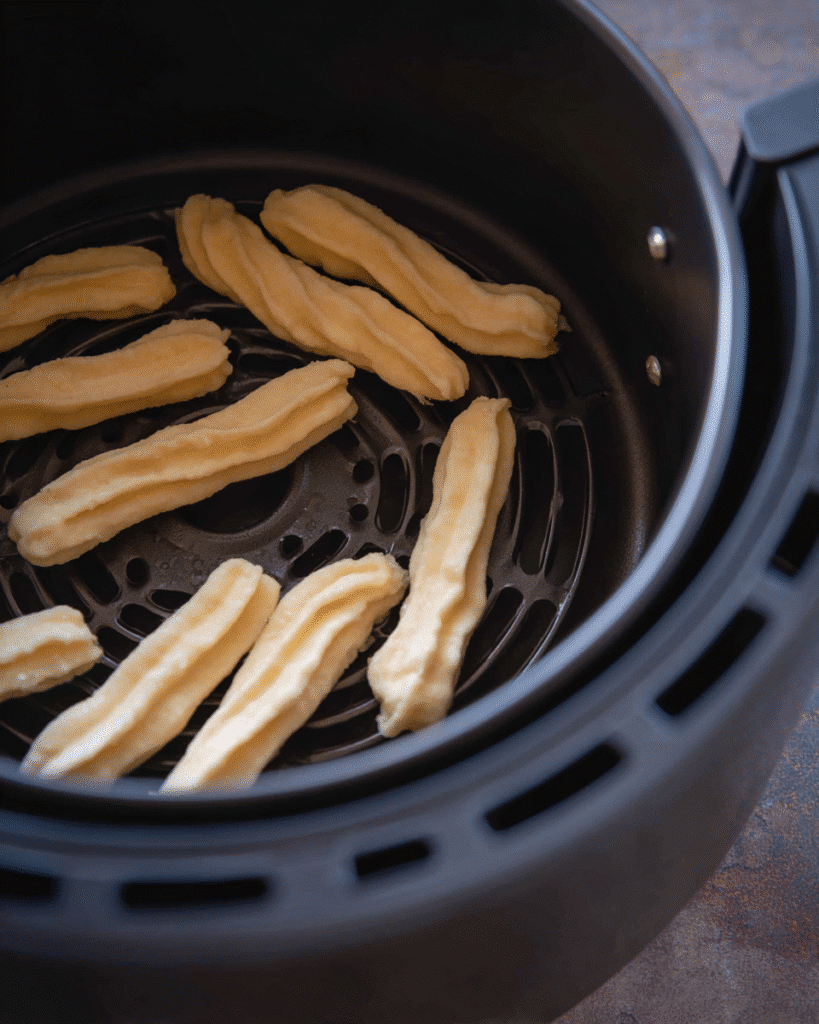 Crispy Air Fryer Churro Bites Recipe 2 Raw Crispy Air Fryer Churro Bites dough piped in basket before cooking
