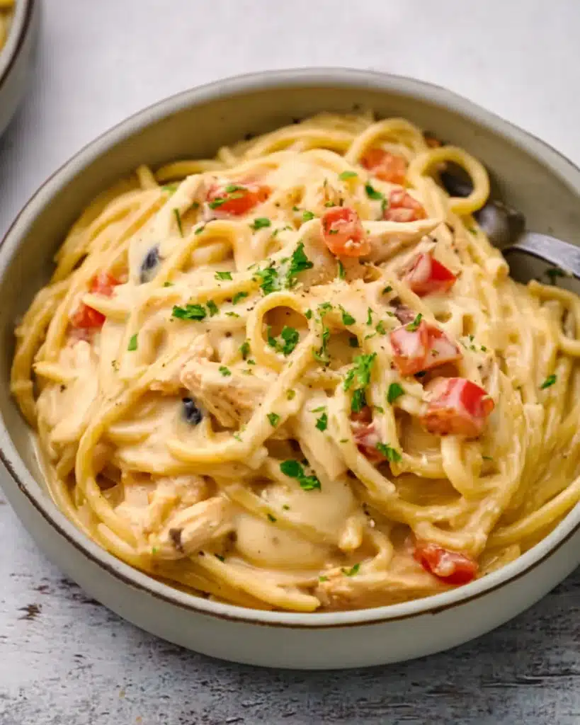 CrockPot Cheesy Chicken Spaghetti Recipe 1 CrockPot Cheesy Chicken Spaghetti Recipe served in a bowl with creamy cheese sauce