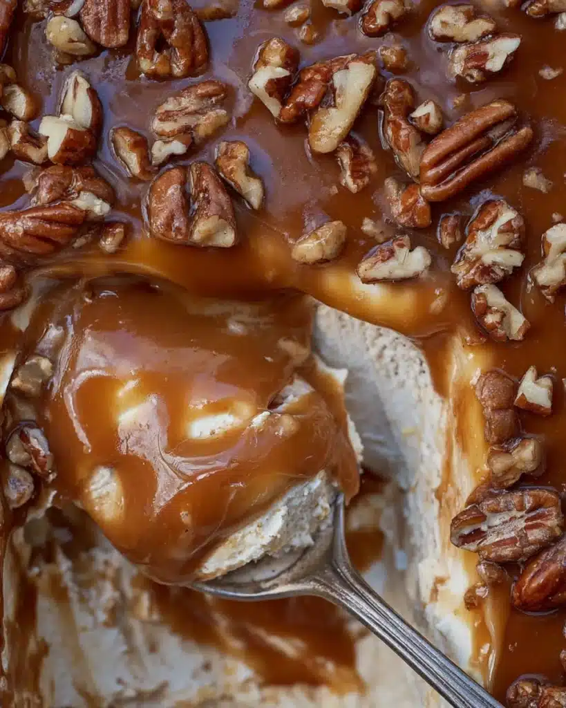 Close-up spoonful of easy caramel apple cheesecake dip with pecans