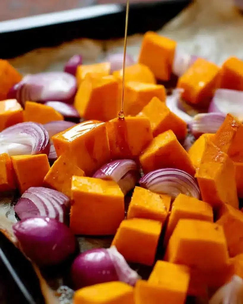 Maple Roasted Pumpkin with Chili and Feta 2 Pumpkin cubes and red onion with maple syrup drizzle before roasting