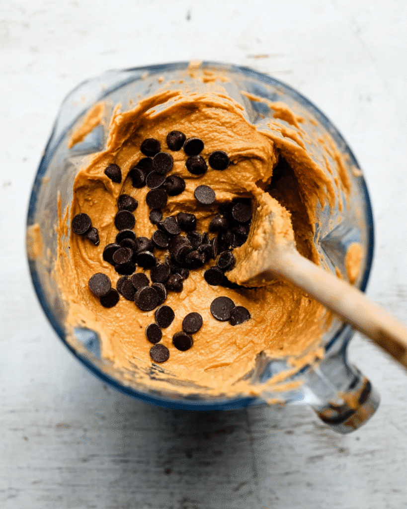 Pumpkin protein muffin batter with chocolate chips in blender