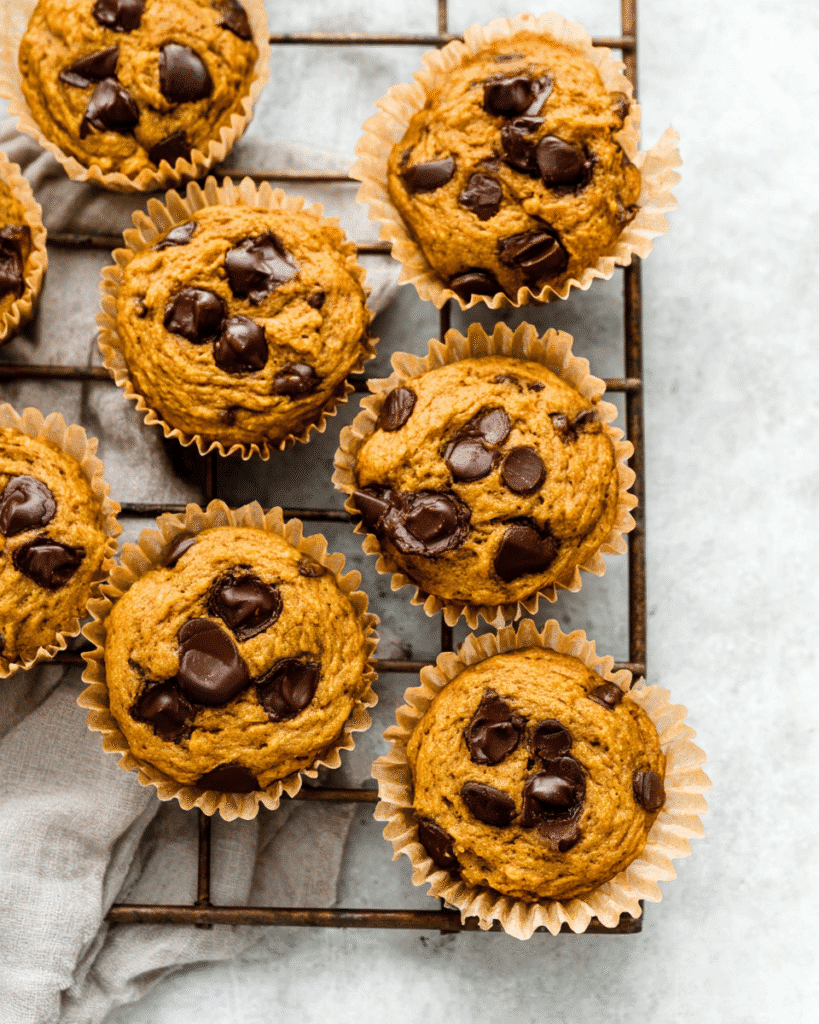 Pumpkin chocolate chip protein muffins cooling on rack