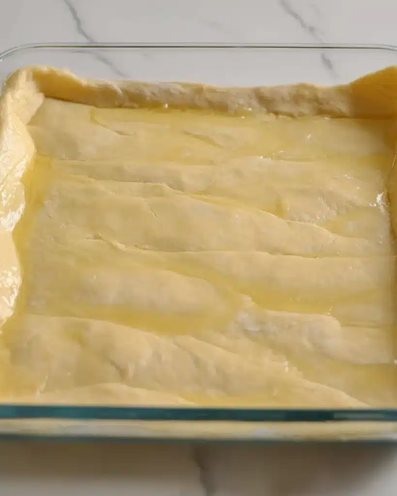 Simple Churro Cheesecake Recipe 2 Crescent roll dough brushed with melted butter for Simple Churro Cheesecake