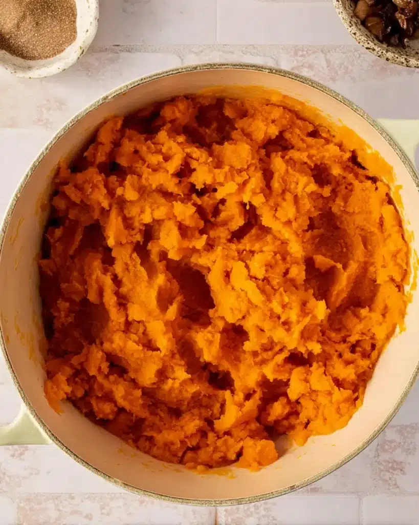 Freshly mashed sweet potatoes in a pot for casserole