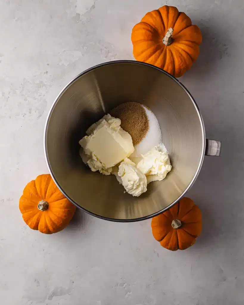 Cream cheese and sugar in mixing bowl for cheesecake filling