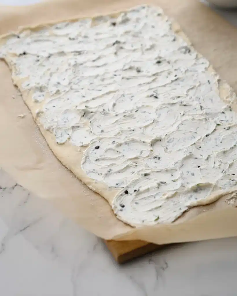 Crescent dough sheet spread with chive cream cheese