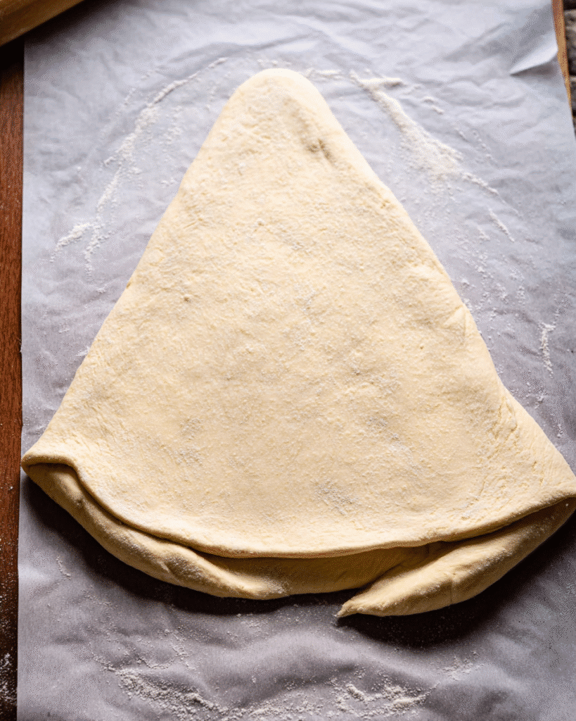 Christmas tree garlic bread dough triangle on parchment paper