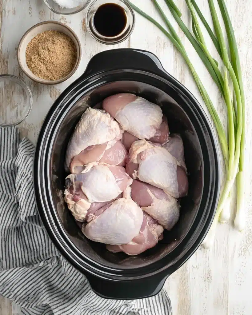 Crock Pot Bourbon Chicken 2 Raw chicken thighs in slow cooker for Crock Pot bourbon chicken recipe