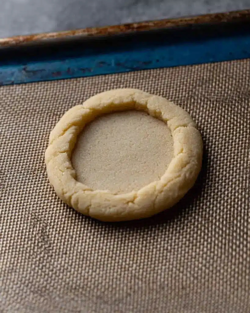 Baked Crumbl pecan pie cookie base with soft center and golden edges