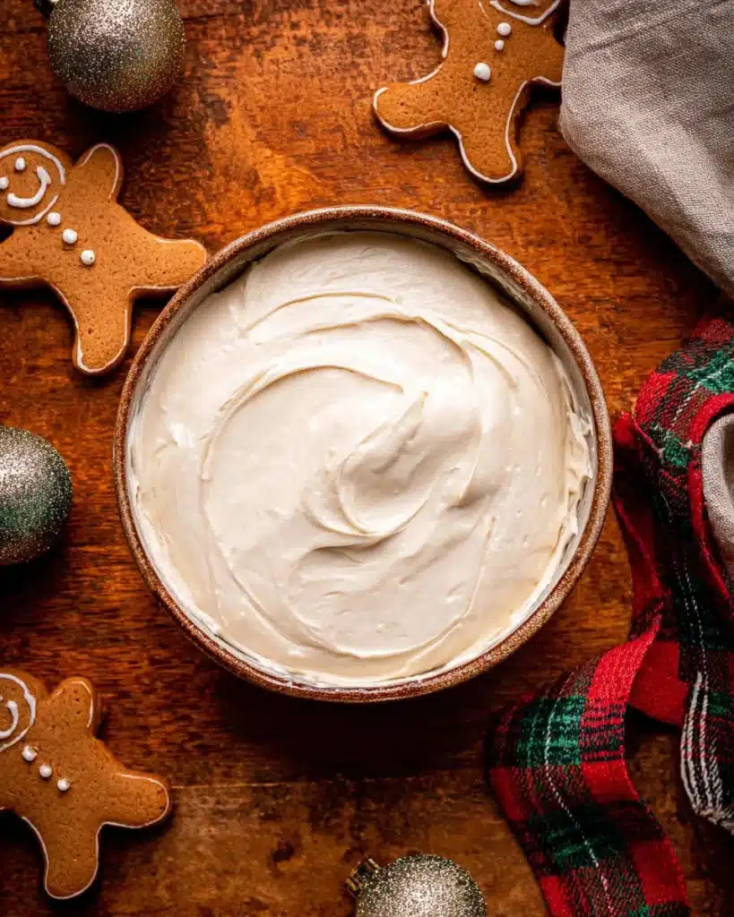 Bowl of creamy cheesecake filling for gingerbread cookies
