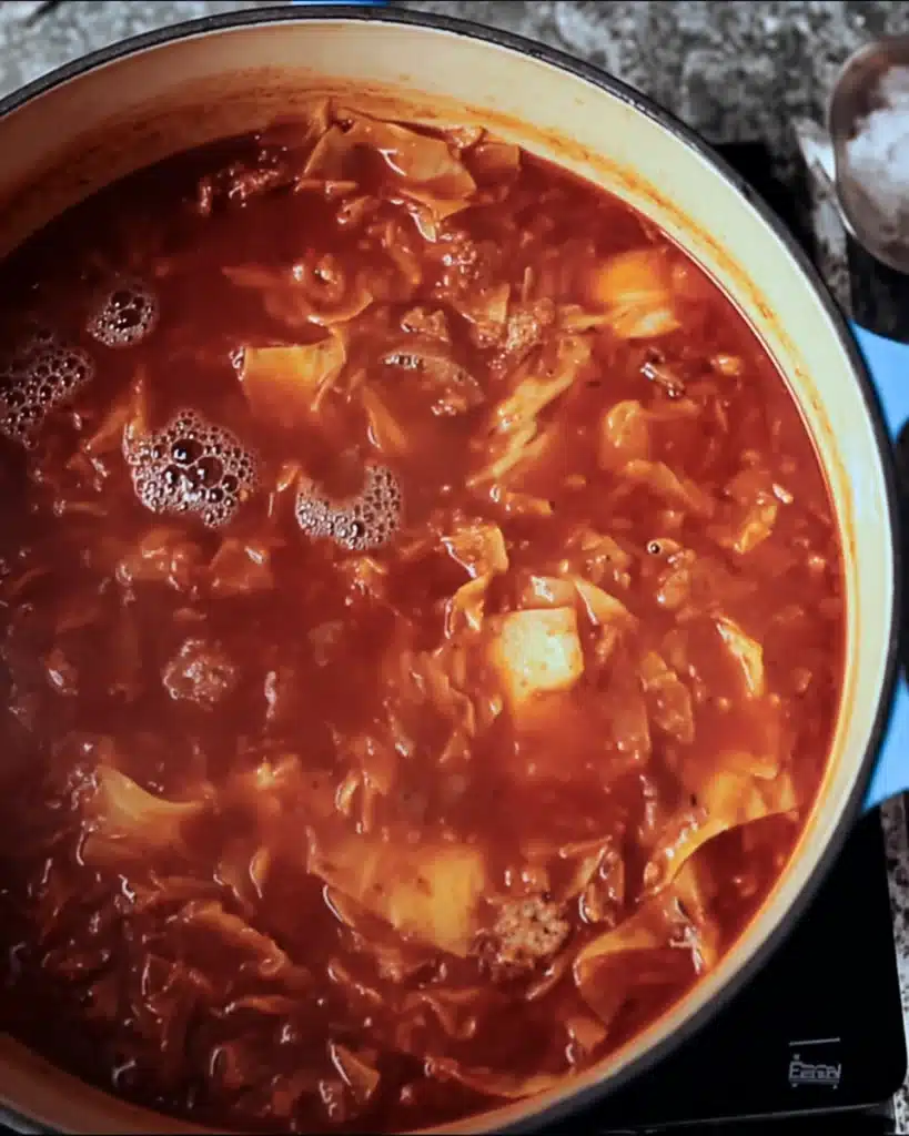 Golumpki Soup simmering in rich tomato broth with cabbage and sausage