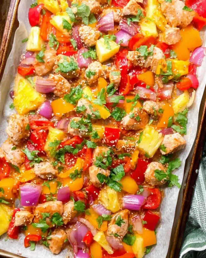 Colorful Hawaiian chicken sheet pan with pineapple, bell peppers, and onions