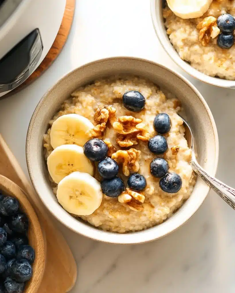 Creamy Instant Pot steel cut oats with bananas, blueberries, and walnuts in a bowl