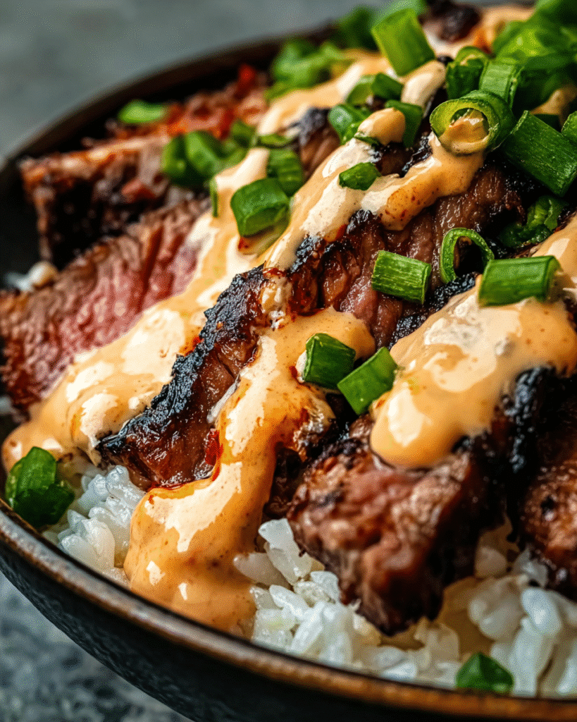 Juicy Korean BBQ steak rice bowl with spicy creamy gochujang sauce