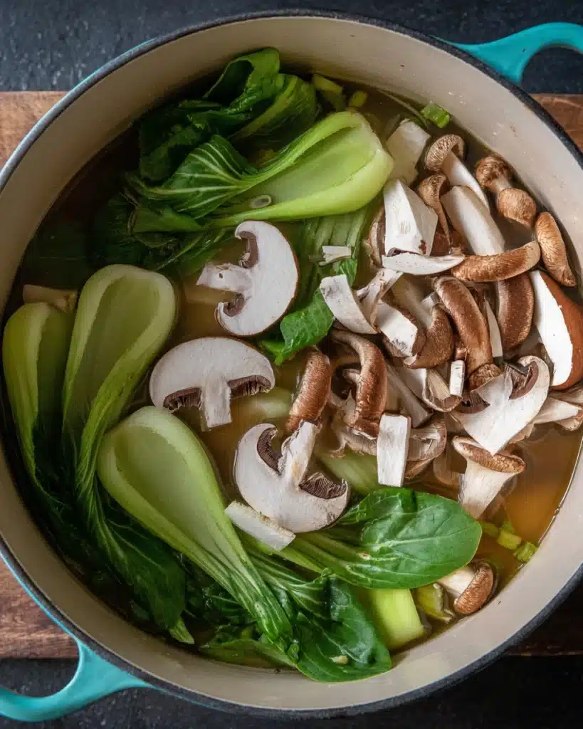 Adding shiitake mushrooms and bok choy to wonton soup broth
