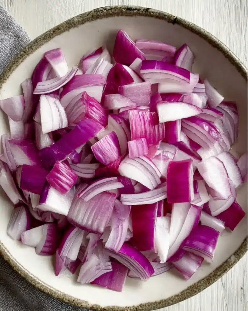 Sheet Pan Beef Kebabs – Easy, Juicy, and Flavorful Dinner 4 Fresh chopped red onions in a bowl for sheet pan beef kebabs