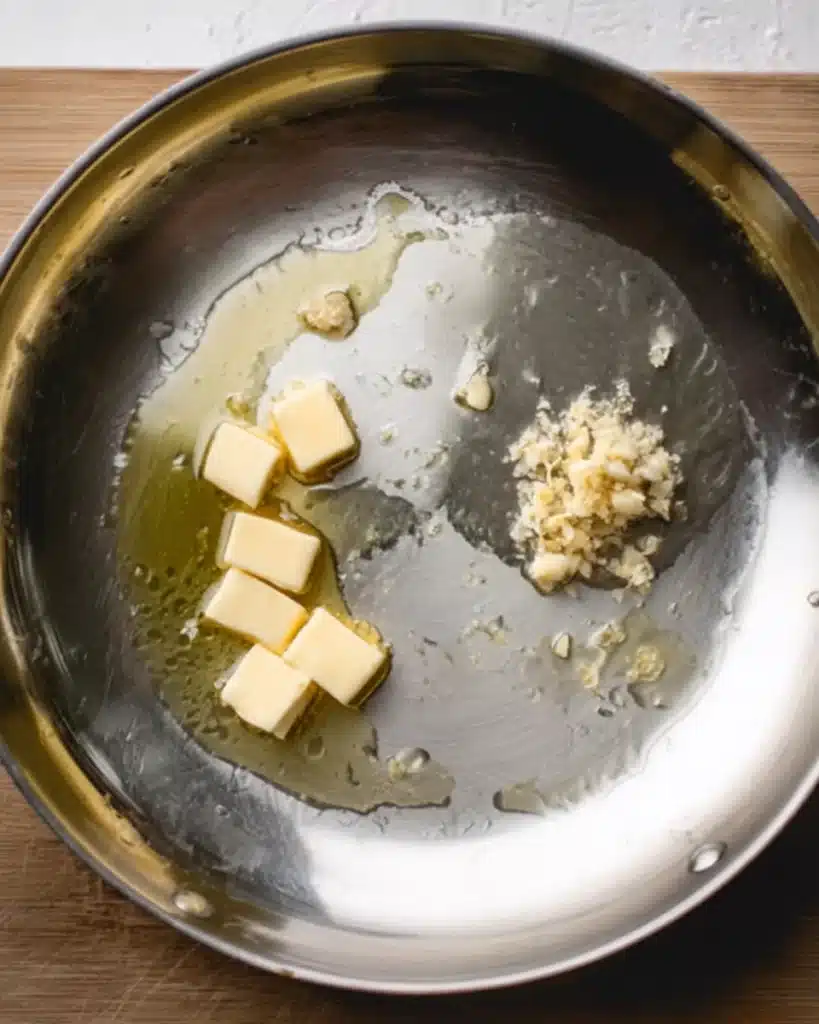 Butter, garlic, and oil in skillet for Tuscan mac and cheese sauce