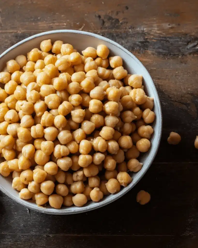 Vegan Garlic Chickpea Soup 2 Bowl of golden chickpeas on rustic wooden table