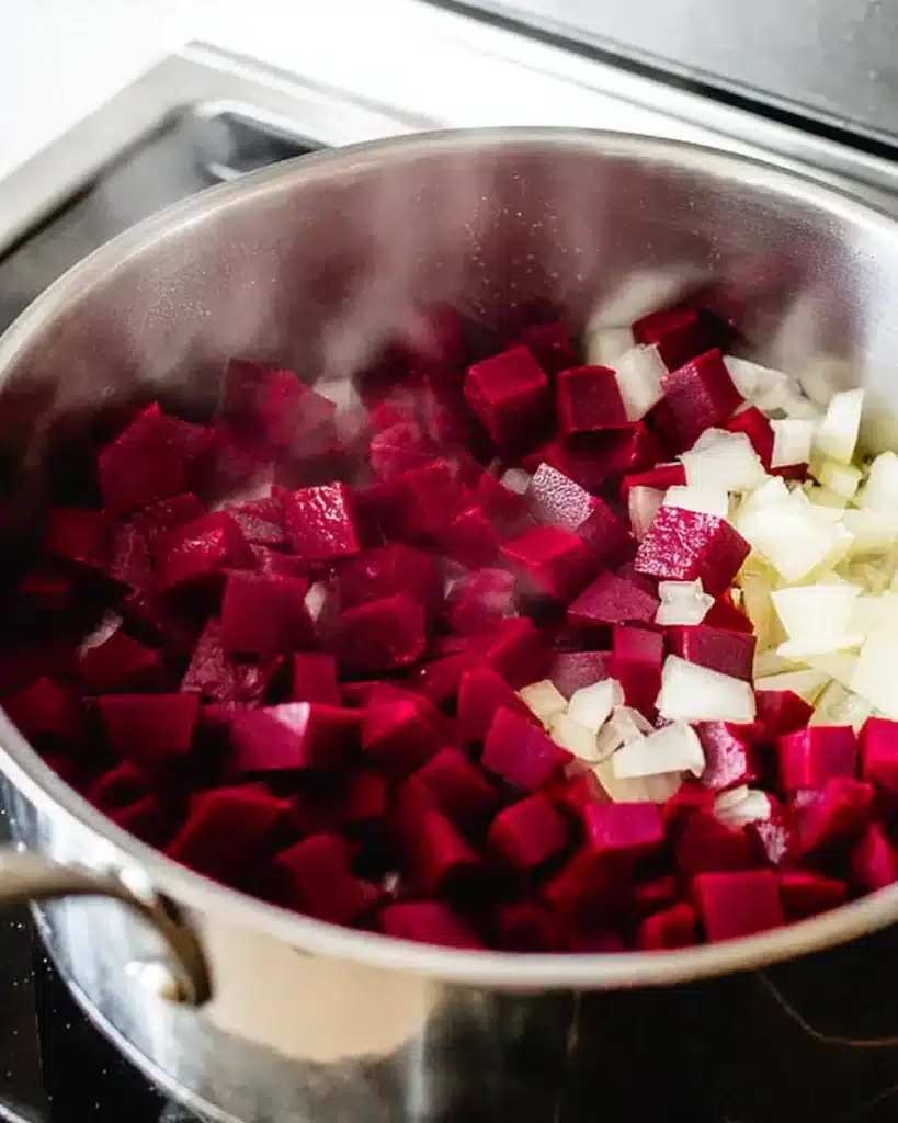 Beet Soup (Smooth and Velvety) 2 Diced beets and onions cooking in a stainless-steel pot