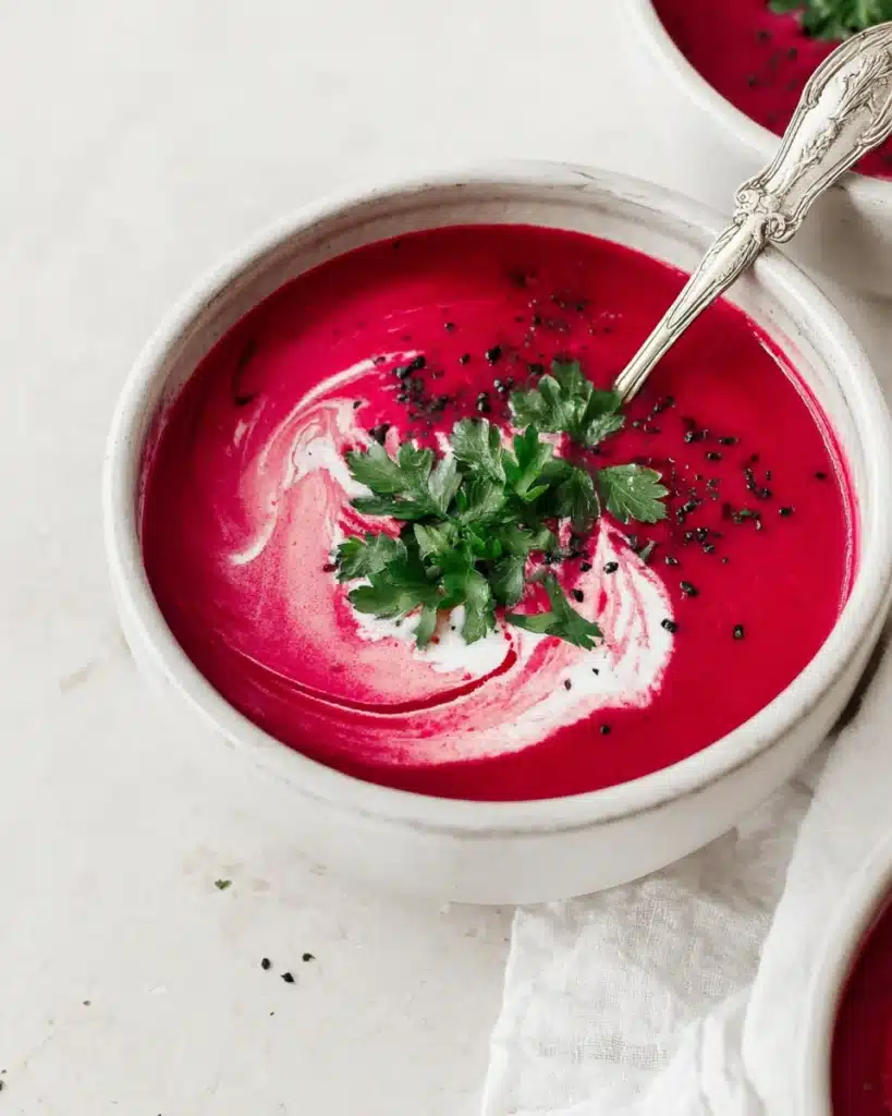 Beet Soup (Smooth and Velvety) 5 Creamy beet soup with coconut cream swirl and parsley garnish