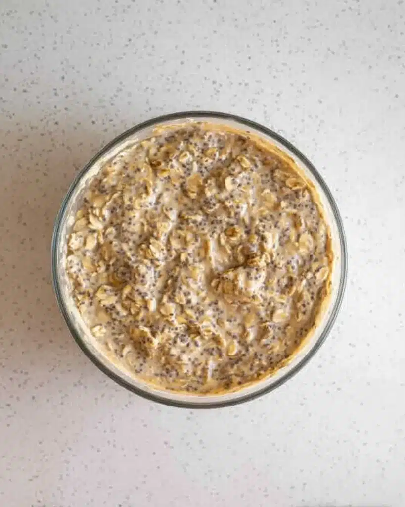 Brown Sugar Overnight Oats 4 Mixed brown sugar overnight oats with banana and chia seeds in a glass bowl