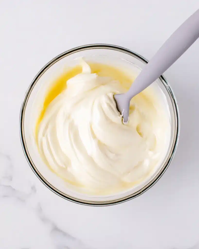 Whipped meringue for fluffy Japanese soufflé pancakes in a glass bowl