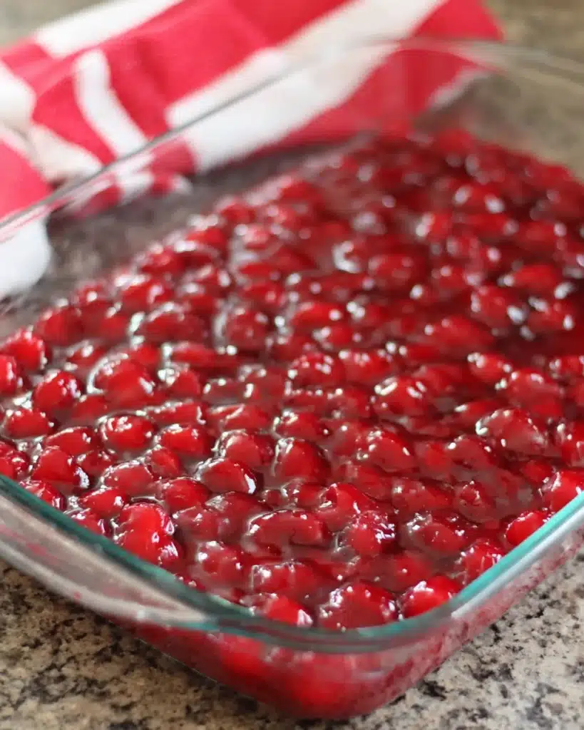 Cherry Dump Cake 2 Cherry dump cake filling in a glass baking dish