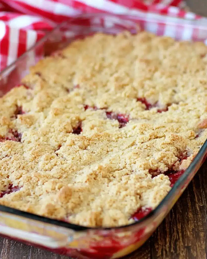 Cherry Dump Cake 4 Baked cherry dump cake with golden crumb topping in glass dish