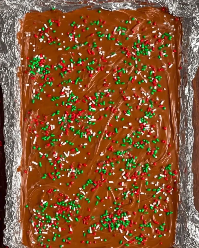 Christmas Crack (Saltine Cracker Toffee Recipe) 4 Melted chocolate topped with red, green, and white sprinkles for Christmas Crack