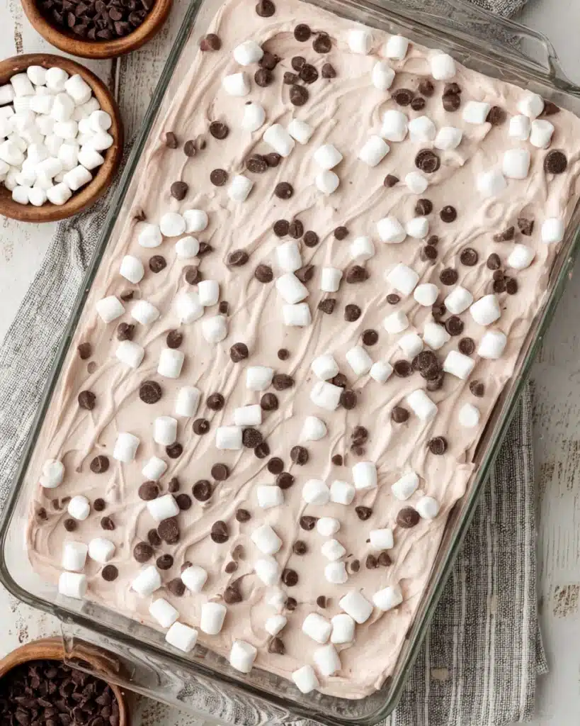 Cocoa Poke Cake (Perfect Christmas Dessert) 3 Finished cocoa poke cake topped with whipped cream, marshmallows, and chocolate chips