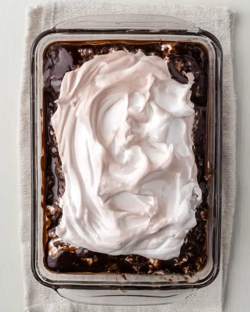 Cocoa Poke Cake (Perfect Christmas Dessert) 2 Chocolate poke cake topped with cocoa whipped cream in a glass pan