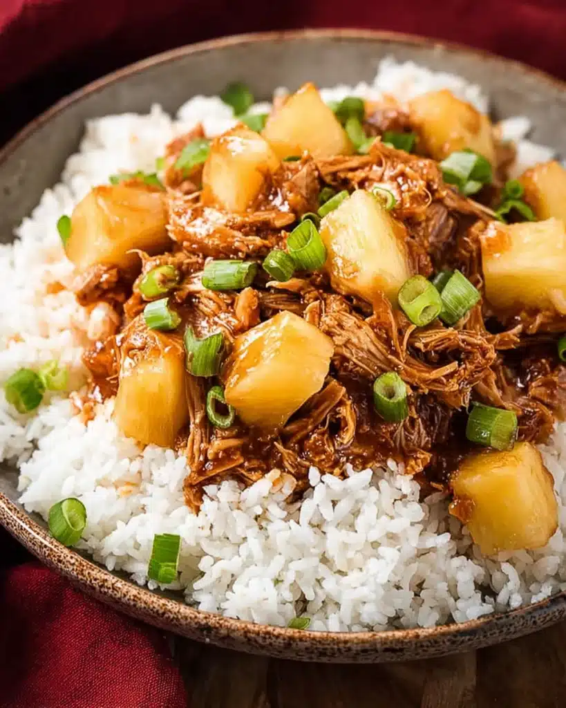 Crockpot Hawaiian BBQ Chicken (Slow Cooker Recipe) 1 Crockpot Hawaiian BBQ Chicken with pineapple over rice in a bowl