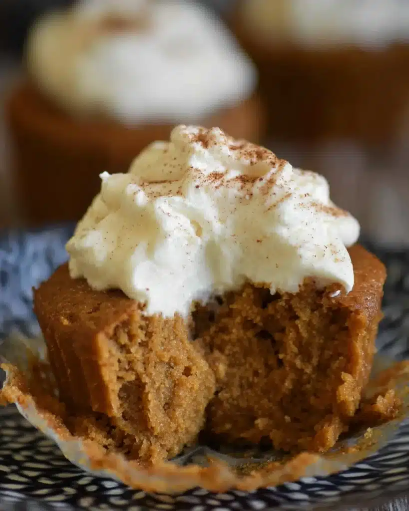 Easy Pumpkin Pie Cupcakes (No Crust Needed!) 2 Half-eaten pumpkin pie cupcake with whipped cream and cinnamon