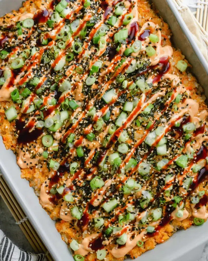 Easy Sushi Bake 6 Top view of easy sushi bake with spicy mayo, cucumber, and unagi sauce drizzle