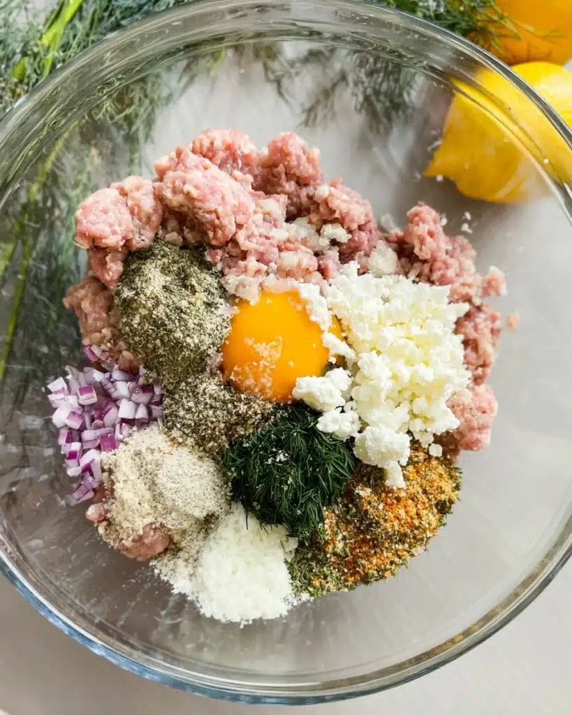 Greek Turkey Meatballs with Tzatziki | A Healthy Mediterranean Dinner 3 Ground turkey mixture with feta, herbs, and spices in a glass bowl