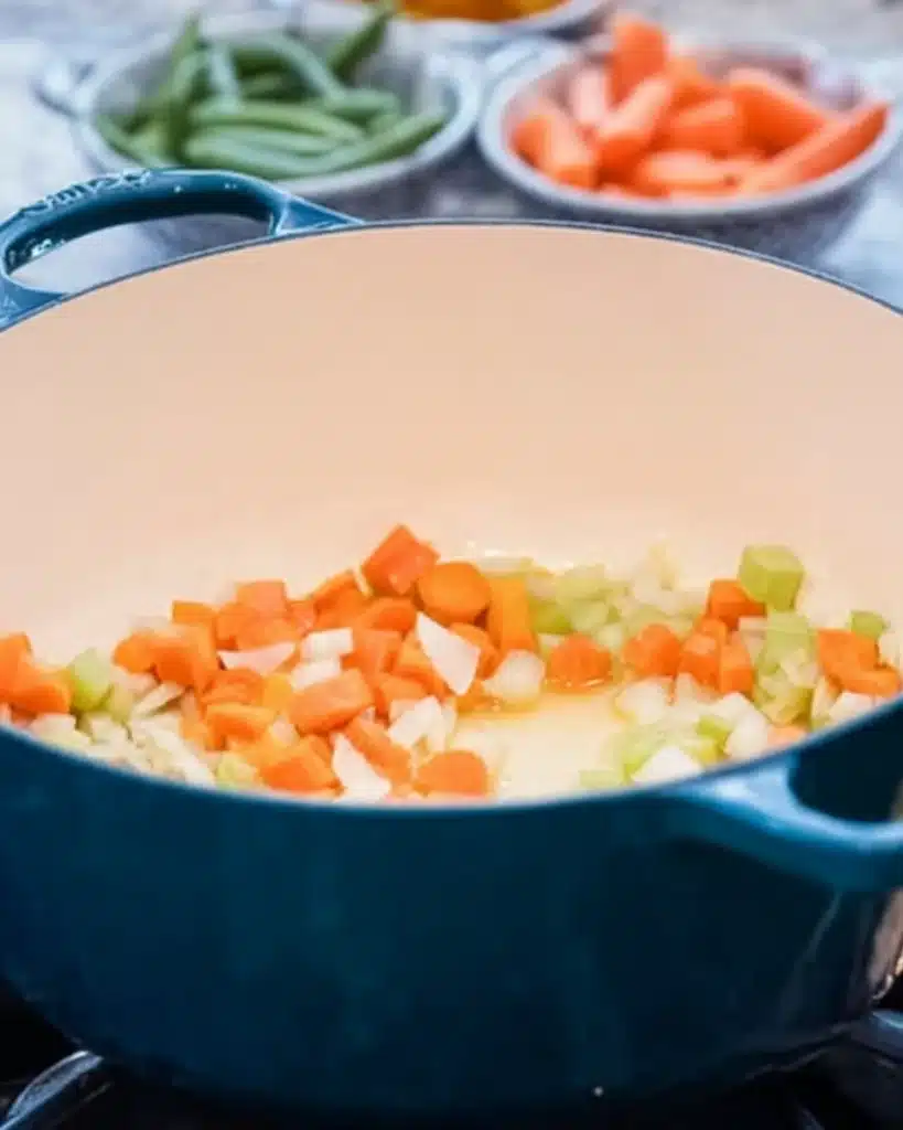 Sautéing onions, carrots, and celery in a Dutch oven for Maryland Crab Soup