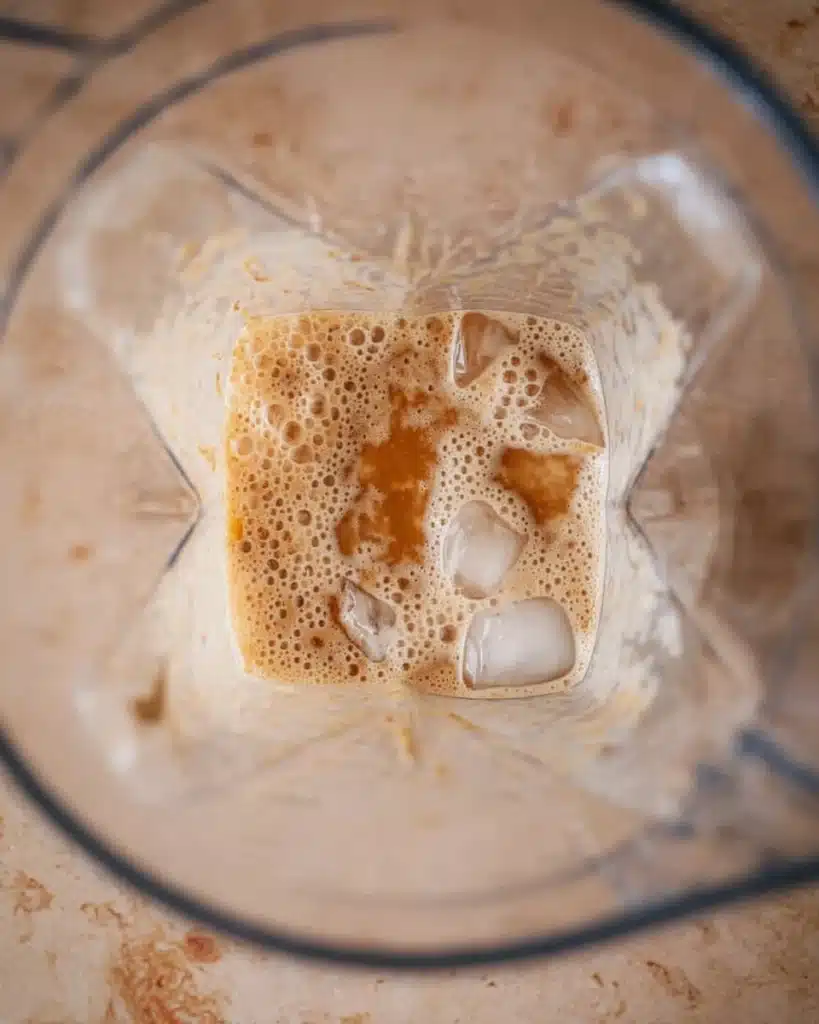 Blender mixing coffee, milk, caramel, and ice for McDonald’s Caramel Frappe