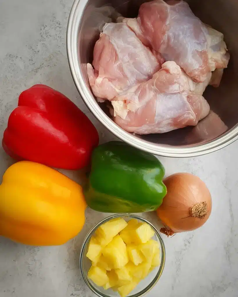 Sweet and Sour Chicken Recipe (Better Than Takeout!) 2 Fresh ingredients for sweet and sour chicken including chicken, peppers, onion, and pineapple