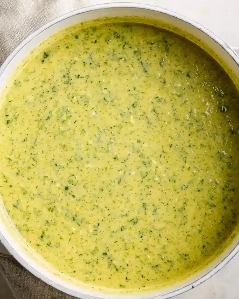 Blended creamy zucchini soup in white pot