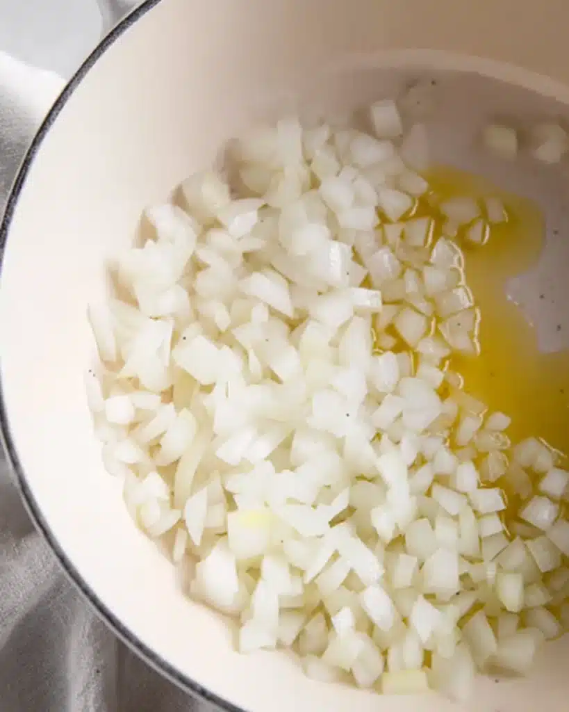 Chopped onions in pot with olive oil for zucchini soup