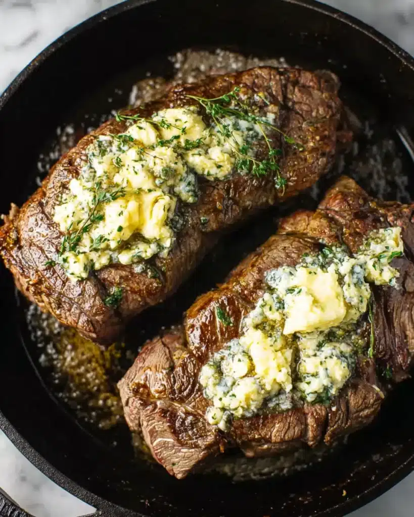Perfect Beef Tenderloin Roast (A Christmas Showstopper) 4 Beef tenderloin roast topped with melting garlic herb butter in cast iron skillet