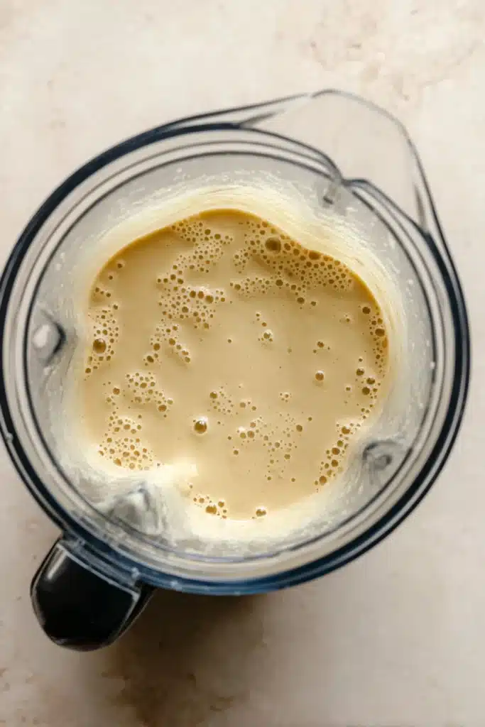 Cheddar Cauliflower Soup 4 Creamy blended cheddar cauliflower soup in a blender ready to simmer